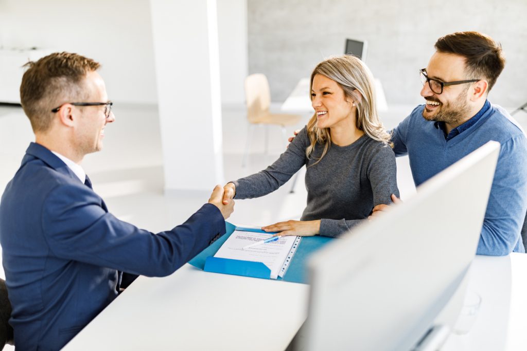 estate agent and client shaking hands