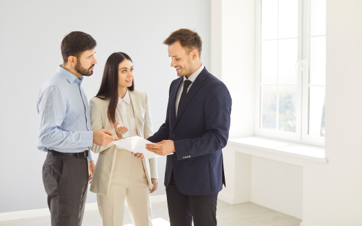 Couples discussing with estate agents